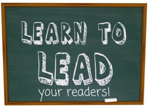 chalk board with "learn to lead your readers!" on it
